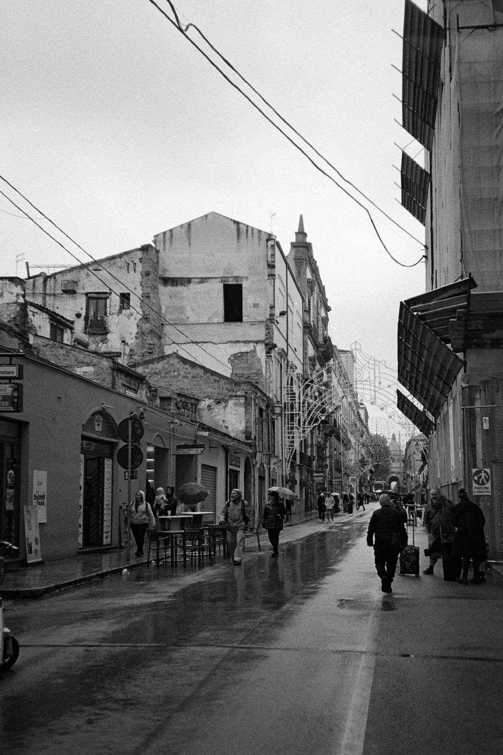 A street with Christmas lights in a rainy day.